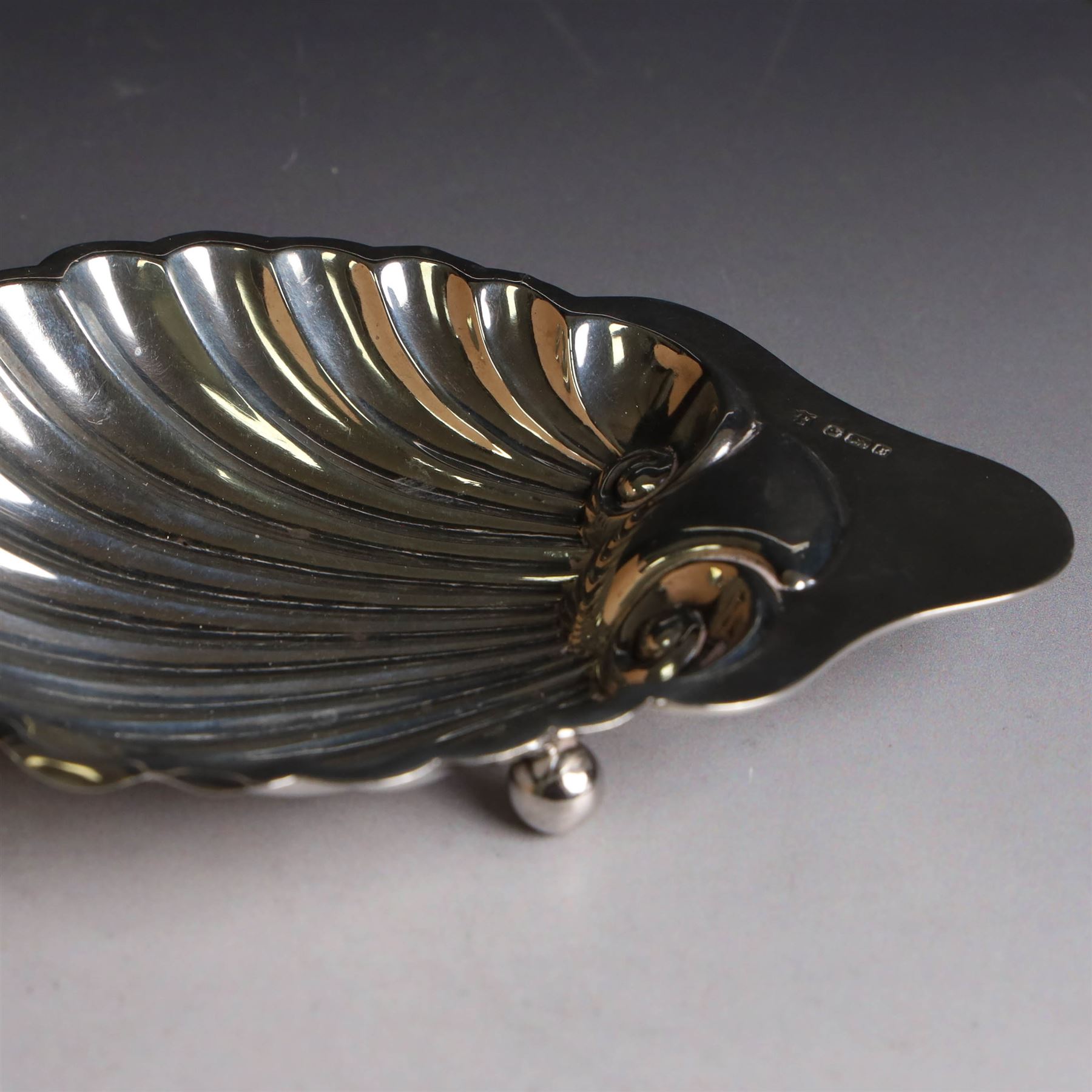Edwardian silver clam shell butter dish, upon three bun feet, hallmarked James Deakin & Sons, Sheffield 1910