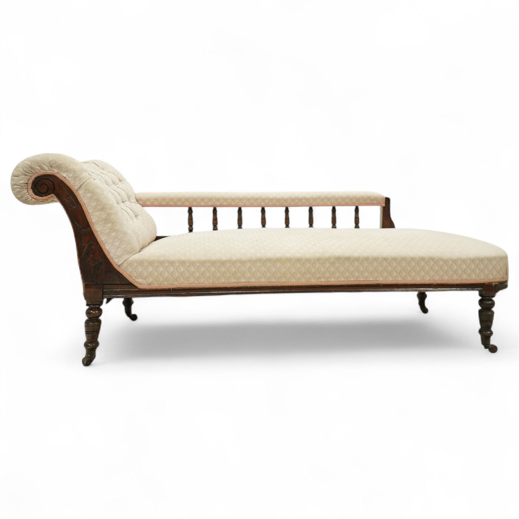 Late 19th century cream upholstered chaise longue, patterned pale damask fabric, padded arm with spindle back gallery raised on turned legs upon castors