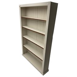 20th century cream painted open bookcase, fitted with four shelves on plinth base