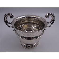 20th century silver twin handled trophy cup, the body with central girdle, personal engraving and twin flying scroll handles, upon a spreading circular foot, hallmarked Birmingham, makers mark and date letter worn and indistinct, including handles H15.5cm D15cm, approximate weight 9.43 ozt (293.6 grams)