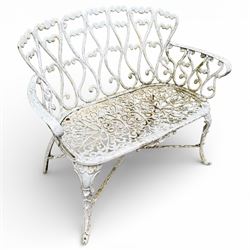 White cast metal garden bench in an antique style