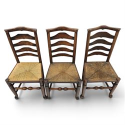 Set of seven (6+1) Georgian design country elm Lancashire dining chairs, ladder backs with rush seats, turned front leg stretcher on pad feet, height of seat 44cm, complete with fitted tie on cushions