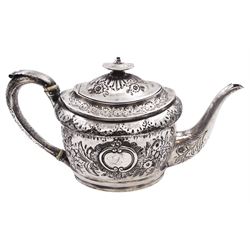 George III silver teapot, of oval form, with embossed foliate, floral and scroll decoration and engraved central cartouche, with acanthus capped C handle with ivory insulators, hallmarked John Emes, London 1807 This item has been registered for sale under Section 10 of the APHA Ivory Act
