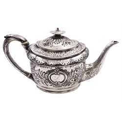 George III silver teapot, of oval form, with embossed foliate, floral and scroll decoration and engraved central cartouche, with acanthus capped C handle with ivory insulators, hallmarked John Emes, London 1807 This item has been registered for sale under Section 10 of the APHA Ivory Act
