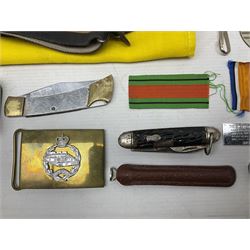 Miscellaneous militaria including two Royal Artillery and one Royal Horse Artillery stable belts; Northamptonshire Regiment trench art brass shell case lighter; unused Matchless Fire-Set; pocket knives and multi-tool; lanyards; oak shield with York & Lancaster crest etc
