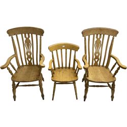 Pair of 20th century beech farmhouse design armchairs, pierced and shaped central splat over shaped saddle seat, raised on ring turned supports with H-stretcher; and a similar side chair