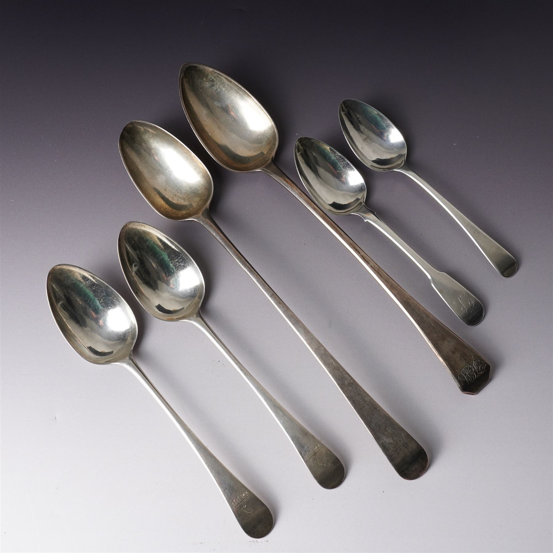 George III silver basting spoon London 1772, another engraved with initials London 1802 Thomas Wallis II, pair of table spoons London 1791 Maker Peter and Ann Bateman and two dessert spoons