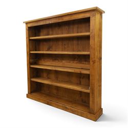 Indigo Furniture - large rustic oak open bookcase, with four adjustable shelves, above a plinth base 