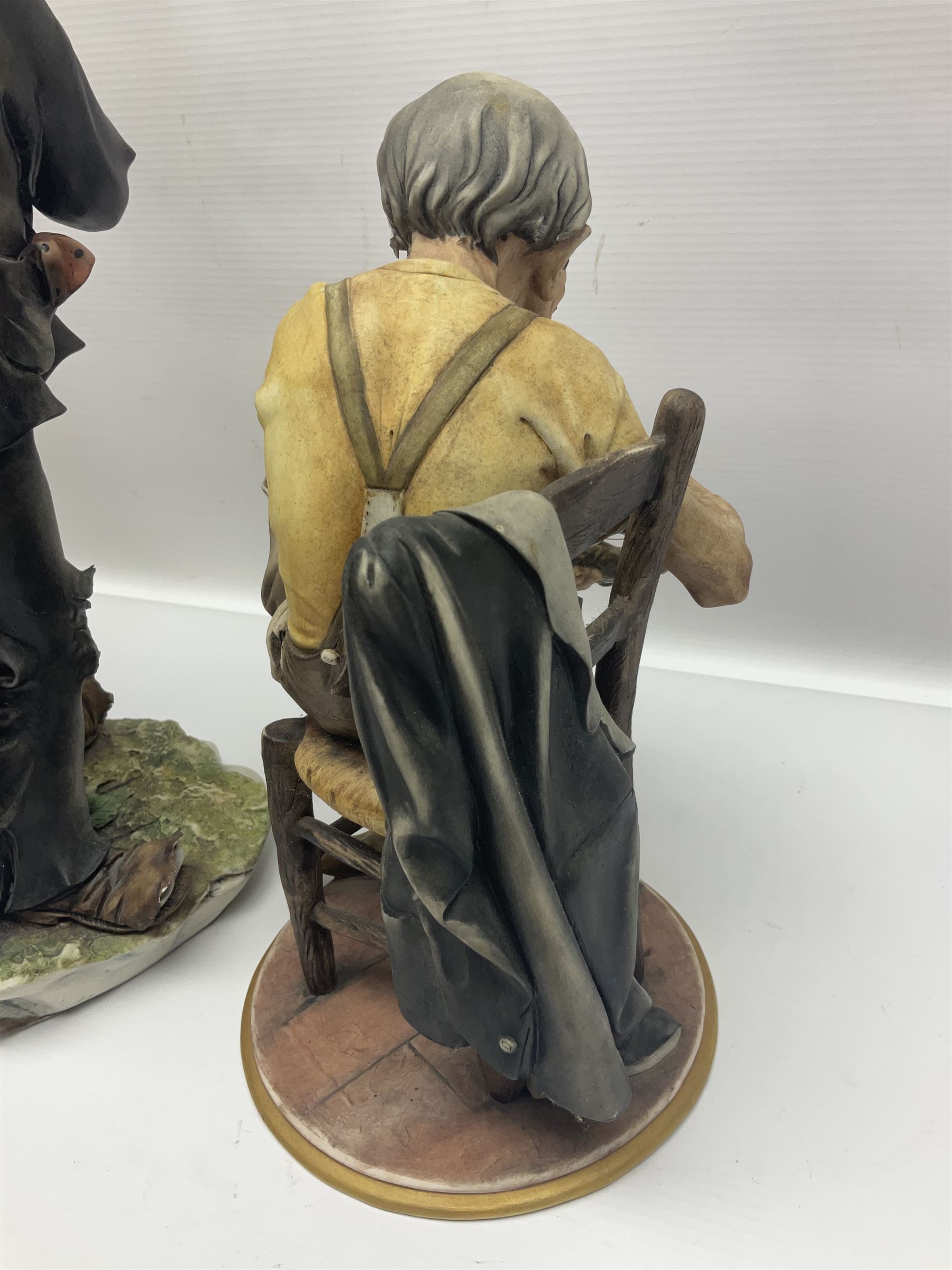 Three Capodimonte figures, to include The Kind Heart Man, modelled by Cortese as a tramp with two doves, The Young Falconer by Maria Angela and another modelled as a tramp darning his socks, all with printed marks, tallest H39cm