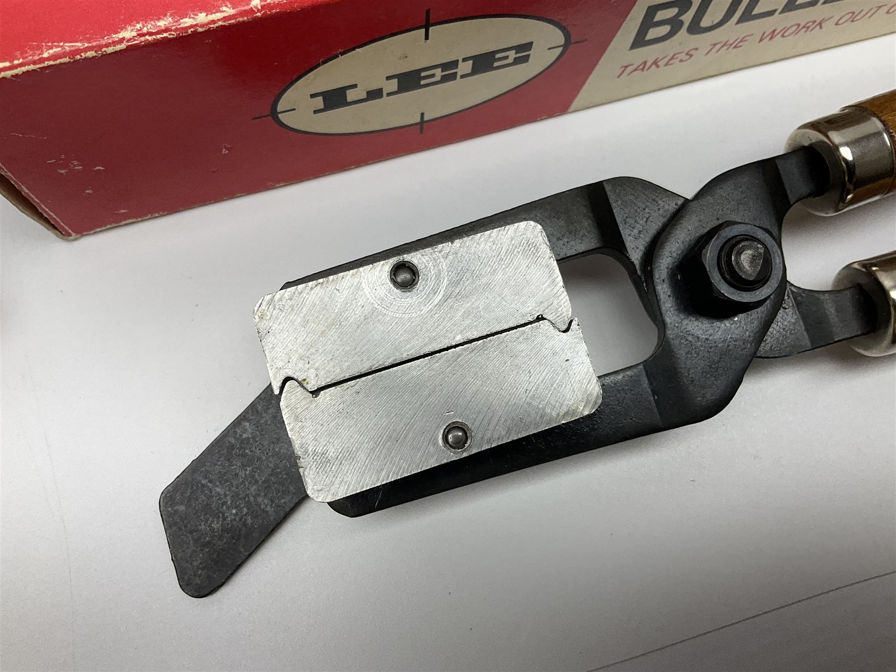 Three modern bullet moulds comprising Lee double cavity .44 calibre, boxed with instructions; and two Lyman .38 calibre; all in unrelated 19th century mahogany box