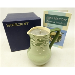  Early 20th century James Macintyre 'Gesso Faience' jug with pewter hinged cover, H17.5cm, with Moorcroft box and 'James Macintyre Pottery & Porcelain reference book by Julie Cufflin (3)  