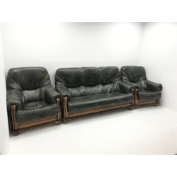 Three seat oak framed sofa upholstered in dark green leather (W180cm) and two matching armchairs (W90cm)
