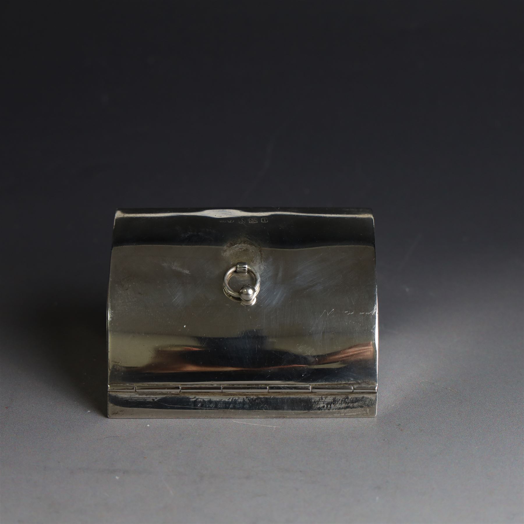 Edwardian silver fall-front ring box with loop handle, opening to reveal velvet interior with five ring spaces, hallmarked Deakin & Francis, Birmingham 1907, together with a cut glass jar with silver lid inscribed 'Hair Tidy' and a silver mounted capstan inkwell, both hallmarked 