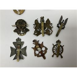 Twenty-three regimental and corps cap badges including Northern Cyclists Battalion, 5th Cinque Ports Battalion, Rifle Brigade, North Riding Rifle Volunteers, Artists Rifles, Finsbury Rifles, REME, RAC, Signals, Catering, Education, Pay, Dental Corps etc ; and an ARP hallmarked silver badge (24)