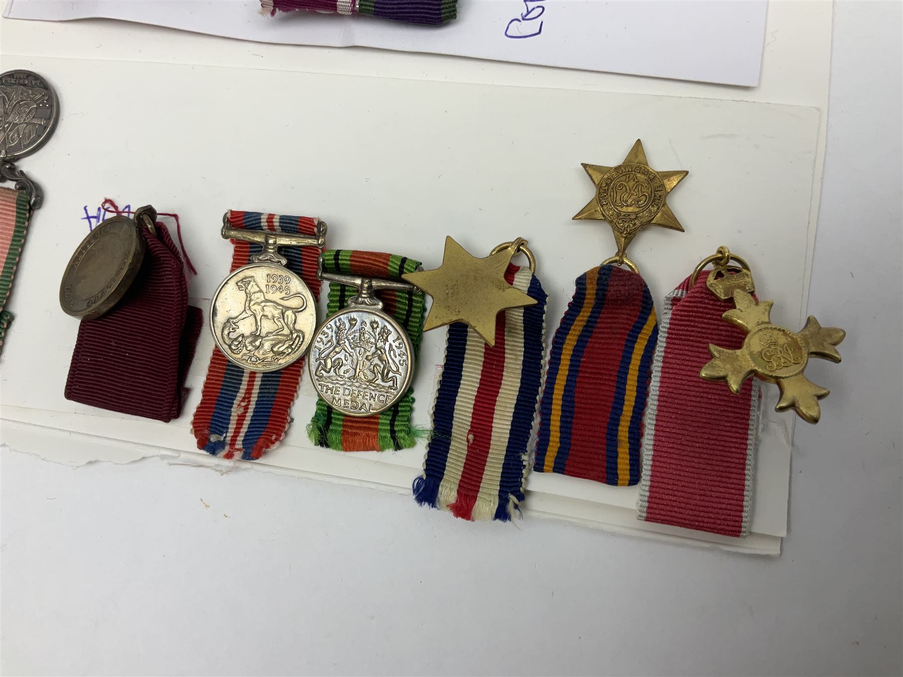 Eleven medal miniatures including Turkish Crimea, OBE (Civil), WW2 Burma Star and France/Germany Star, two pairs of WW2 War/Defence medals, LSGC etc; and two military badges
