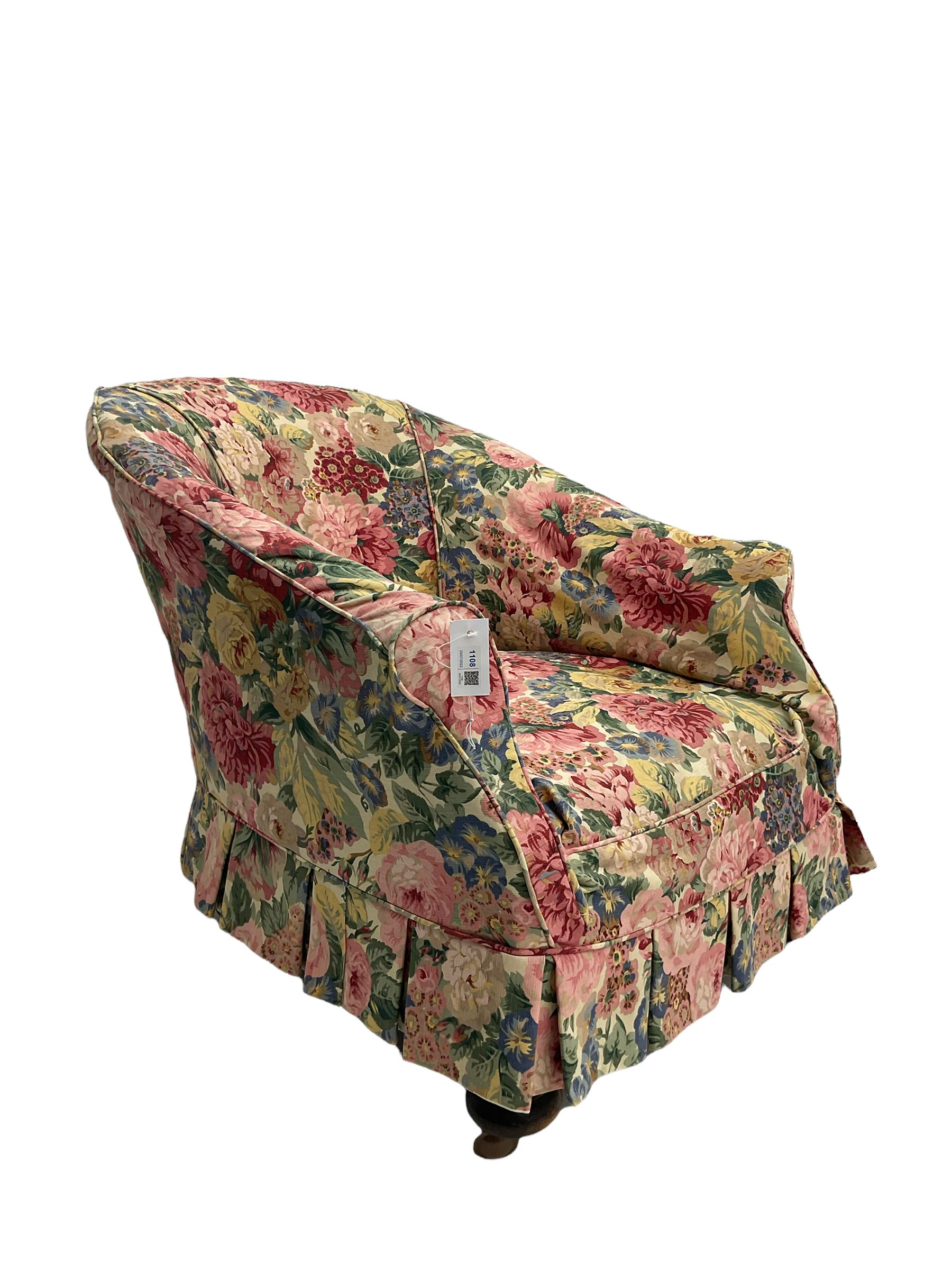 Victorian low tub shaped armchair, beech framed with compressed bun feet, loose floral fabric