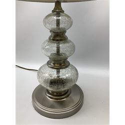 A pair of crackle glass table lamps each of three spheres, on circular metal bases, with silver lampshades, H61cm with shades.  