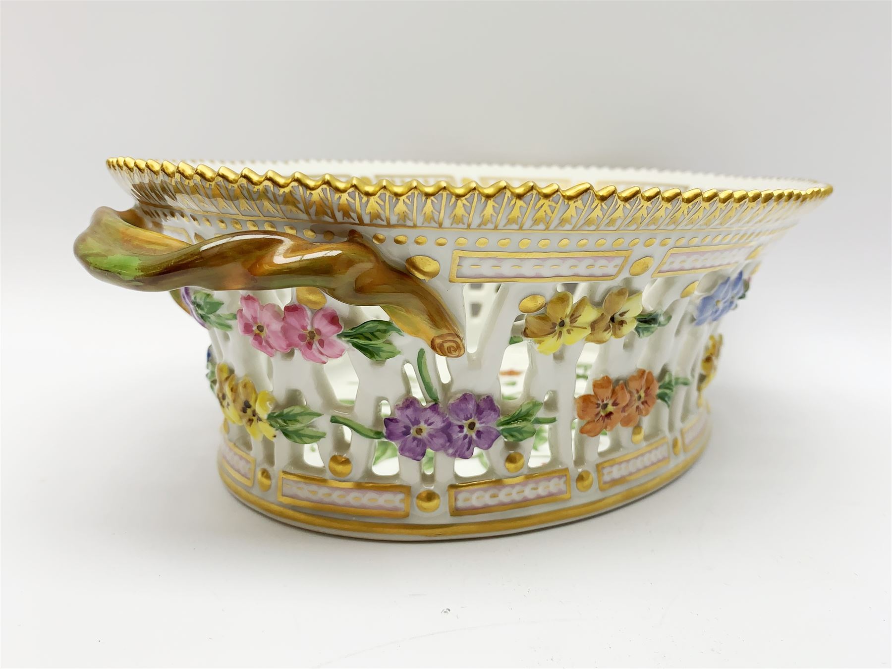 Royal Copenhagen Flora Danica basket, with naturalistically modelled vine handles and reticulated sides detailed with polychrome forget-me-nots, the interior decorated with a botanical study of 'Anagallis arvensis', sprigs and a gilt border, with printed and painted marks beneath, H8cm L26cm 

