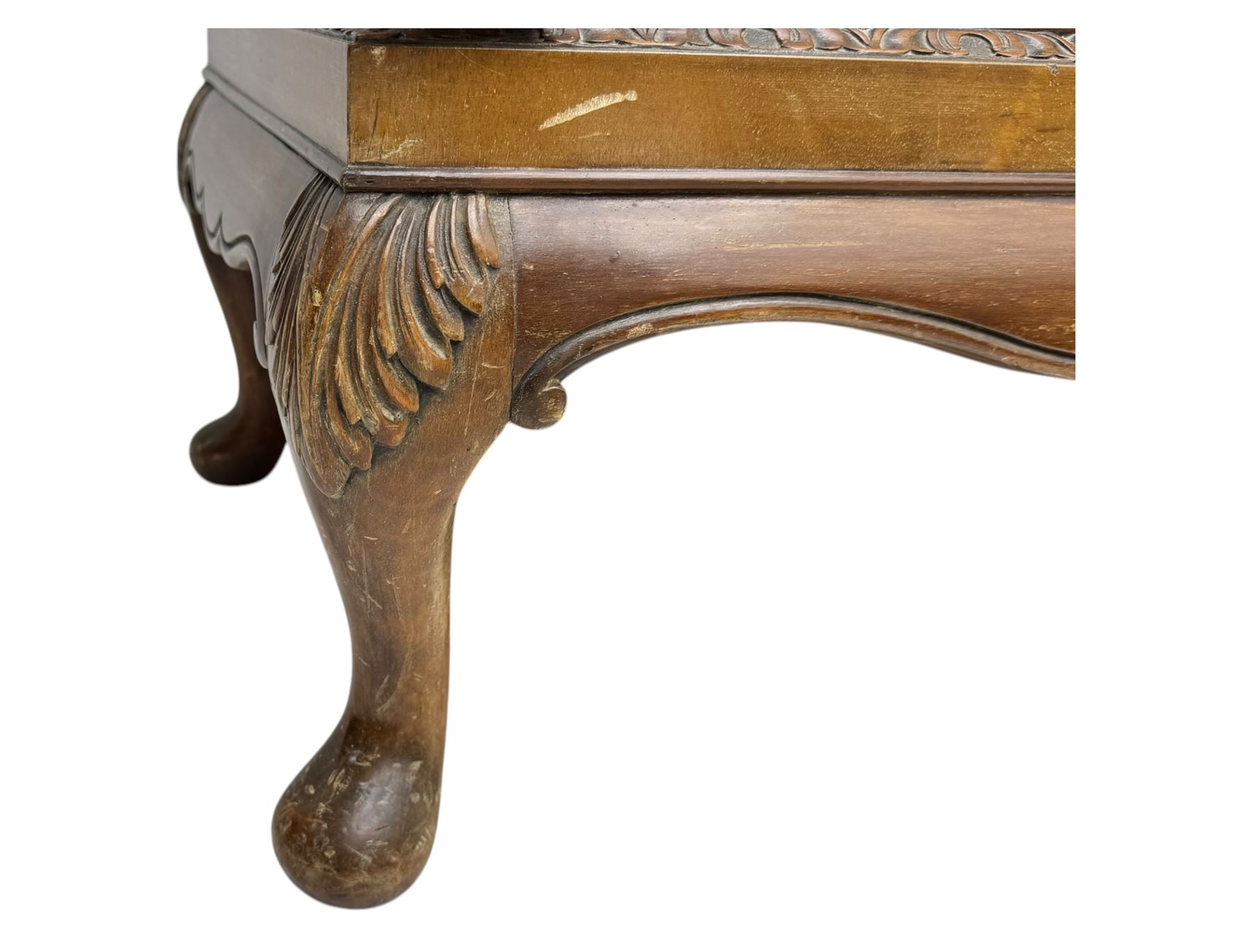 Early 20th century walnut veneered cocktail cabinet, shaped and carved foliate pediment above a pair of arched panelled doors with figured veneers and ornate cast escutcheons, interior is mirrored on the base and back, slide out mirrored shelf, flanked by foliate carved uprights, over a conforming lower cabinet, all raised on shaped apron and scroll carved cabriole feet