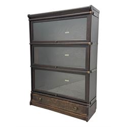 Globe Wernicke - early 20th century oak three-tier stacking library bookcase, three glazed sections enclosed by hinged and sliding doors, raised above a single lower drawer with metal drop handles