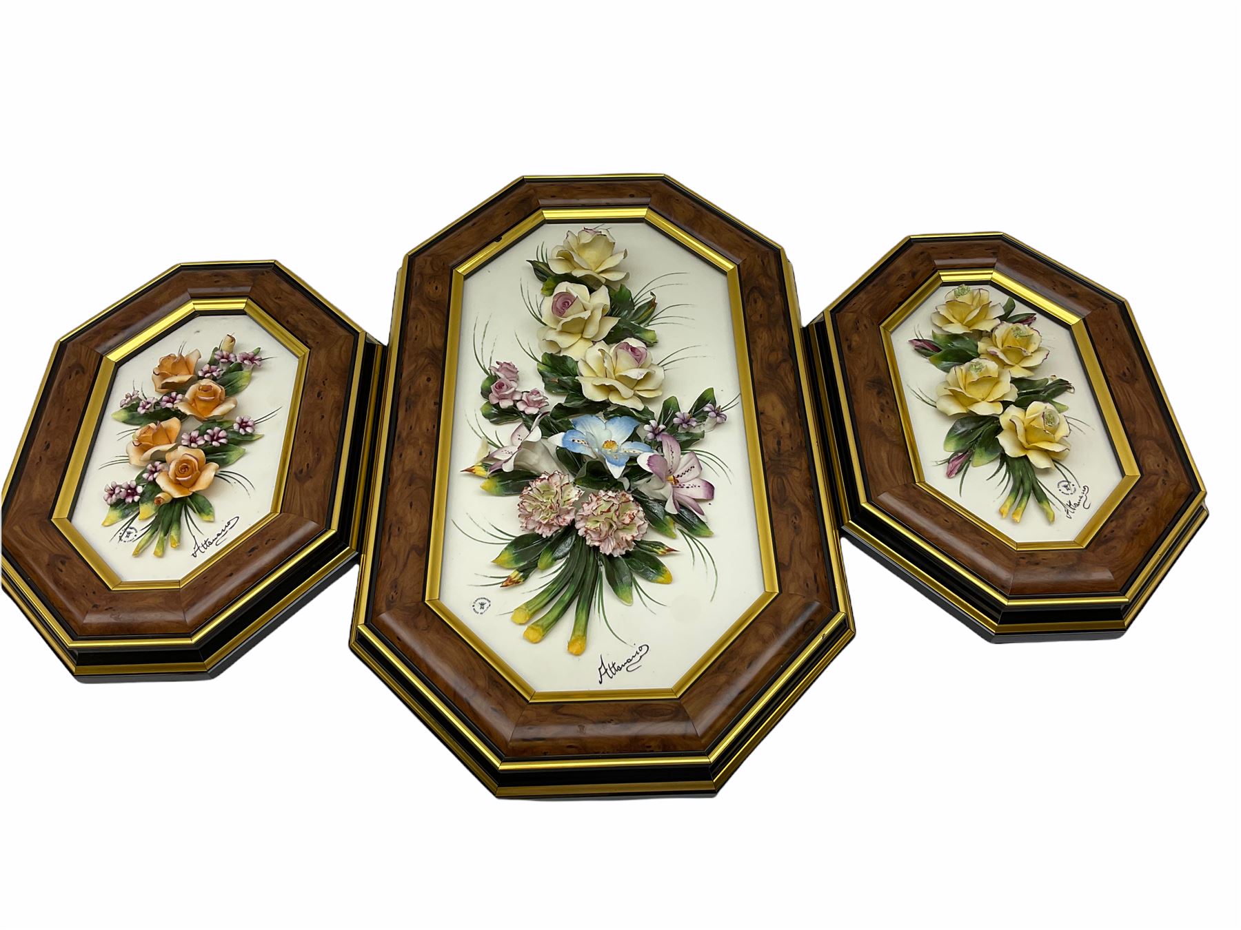 Set of three Capodimonte wall plaques, depicting floral decoration in octagonal frames with gilt edging, largest plaque H48, two small plaques H31cm.    