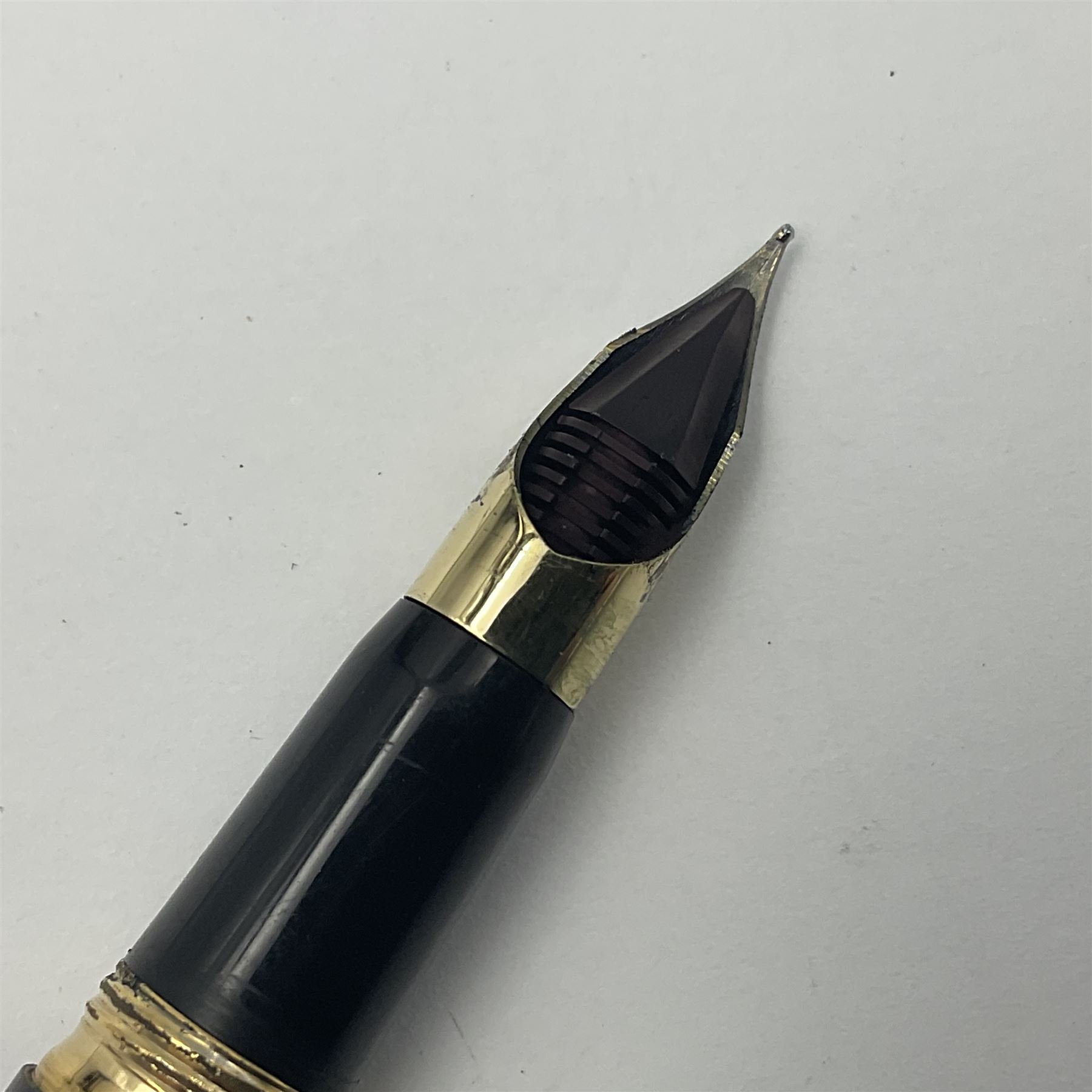 Sheaffer Crest fountain pen, the black barrel with gold plated cap and 18K nib, together with a matching ballpoint pen and further fountain pen, longest L14cm (3)