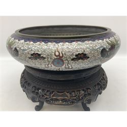 Early 20th century Chinese cloisonne bowl, of squat circular form, the interior decorated with a five clawed dragon chasing a flaming pearl, the exterior with conforming decoration, with character mark beneath, rim D16cm, with carved wooden stand