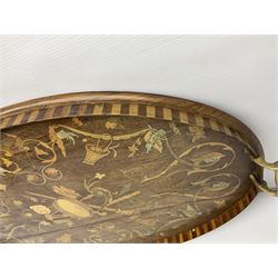 Edwardian twin handled oval marquetry tray, inlaid with instruments, putti, C scrolls and florals, with brass twin handles, together with a similar oval twin handled plain mahogany tray, largest W70cm