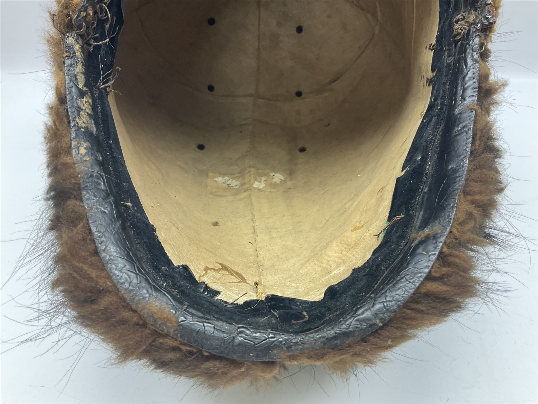 French Grenadier's bearskin hat, the embossed brass plate with crowned eagle, flaming grenades and arrow flashes; leather headband and traces of manuscript label internally