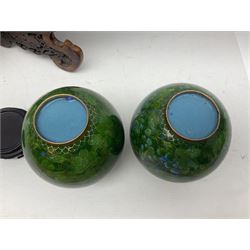 Pair of modern cloisonne ginger jars having floral decoration with a green ground, with hardwood stands, together with a similar plate and a bowl decorated with birds and flowers  