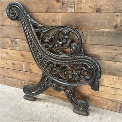 Early 20th century heavy cast iron three piece bench ends, decorated with scrolls and floral swags