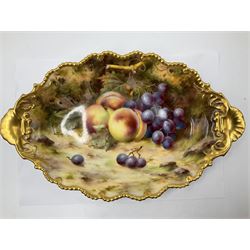 Pair of early 20th century Royal Worcester dishes decorated by Frank Roberts, each of oval form with gilt shaped rim and twin shell handles, hand painted with a still life of fruit upon a mossy ground, signed F Roberts, with puce printed mark beneath and date code for 1918, W31cm