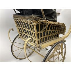 Victorian dolls canework carriage with rexine upholstered interior and folding canopy, painted wooden framework with upward curving handles, on metal sprung strapwork base and two spoked wheels with rubber tyres L90cm