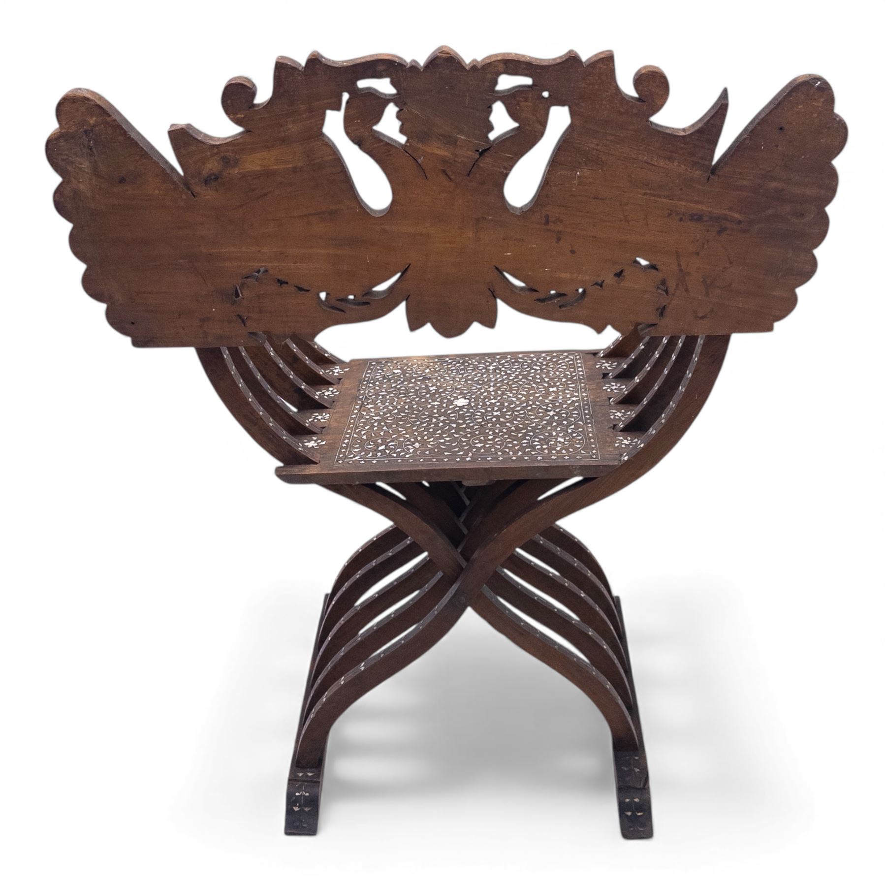 Anglo-Indian bone inlaid hardwood Savonarola chair, the pierced back finely carved with opposing peacocks amongst scrolling foliage, the seat, arms, and X-frame supports. This item has been registered for sale under section 10 of the APHA Ivory Act Reference QWLLGKZM