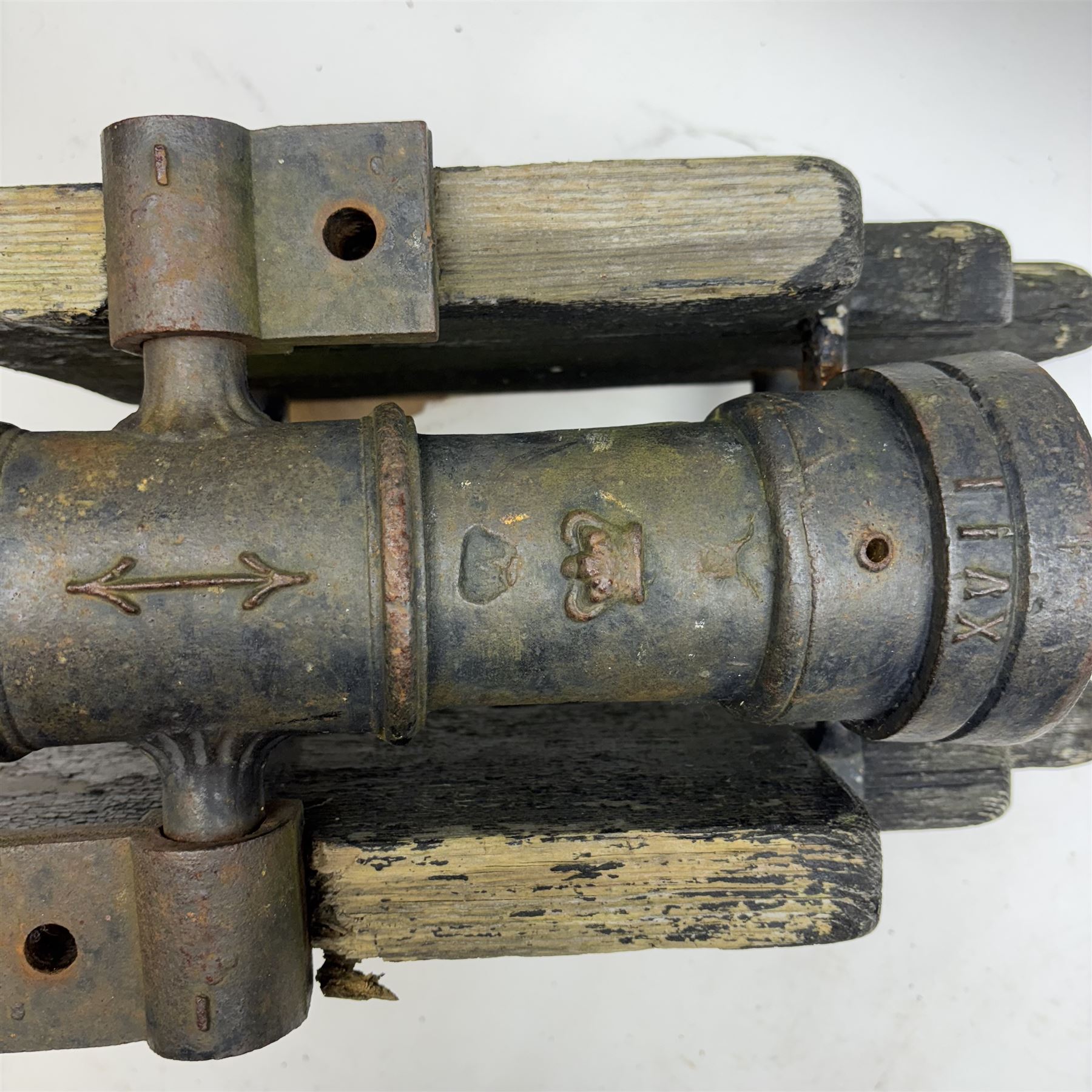 Victorian model of a ship's cannon, the ringed iron barrel with flared muzzle upon an
wooden carriage with four iron wheels, L54cm