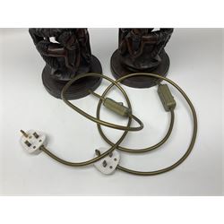 Pair of 20th century carved wood table lamp with African busts and figures, together with a carved wooden figure and soapstone figure, lamps H44cm