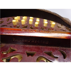  Victorian rosewood hexagonal concertina with fretworked ends and total of thirty-nine bone buttons, one handle impressed English Make with Trade Mark Patent No.4752, leather straps, W18cm, in mahogany hexagonal carrying box  