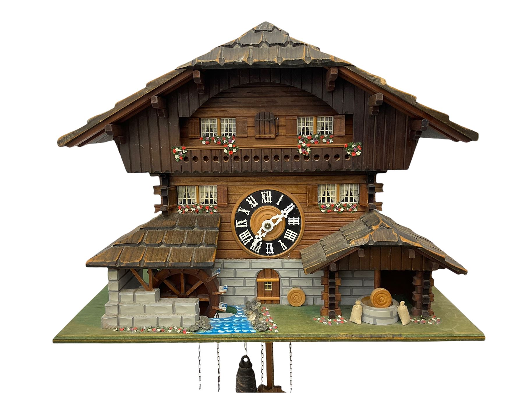 An automaton musical cuckoo clock with a 20th century three weight movement in the form of a Swiss Chalet with a working waterwheel, traditional dial and hands, thirty-hour movement with a cuckoo sounding the hours and half hours on twin bellows, hours followed by one of three tunes played on a musical box and the revolving of the water wheel. With pendulum and weights.




