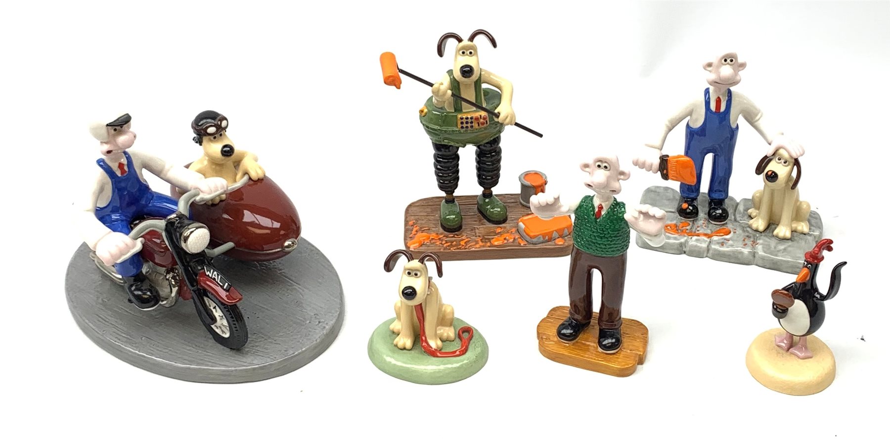 A group of six Coalport Wallace & Gromit figurines, comprising 'Hold on Gromit' no880/2000 with certificate, 'Decorating in Techno Trousers' no1195/2000 with certificate, 'Reading for Take Off', 'Do something Gromit', 'Feathers in disguise', 'Happy Birthday Gromit', each in maker's box with accompanying swing tag.