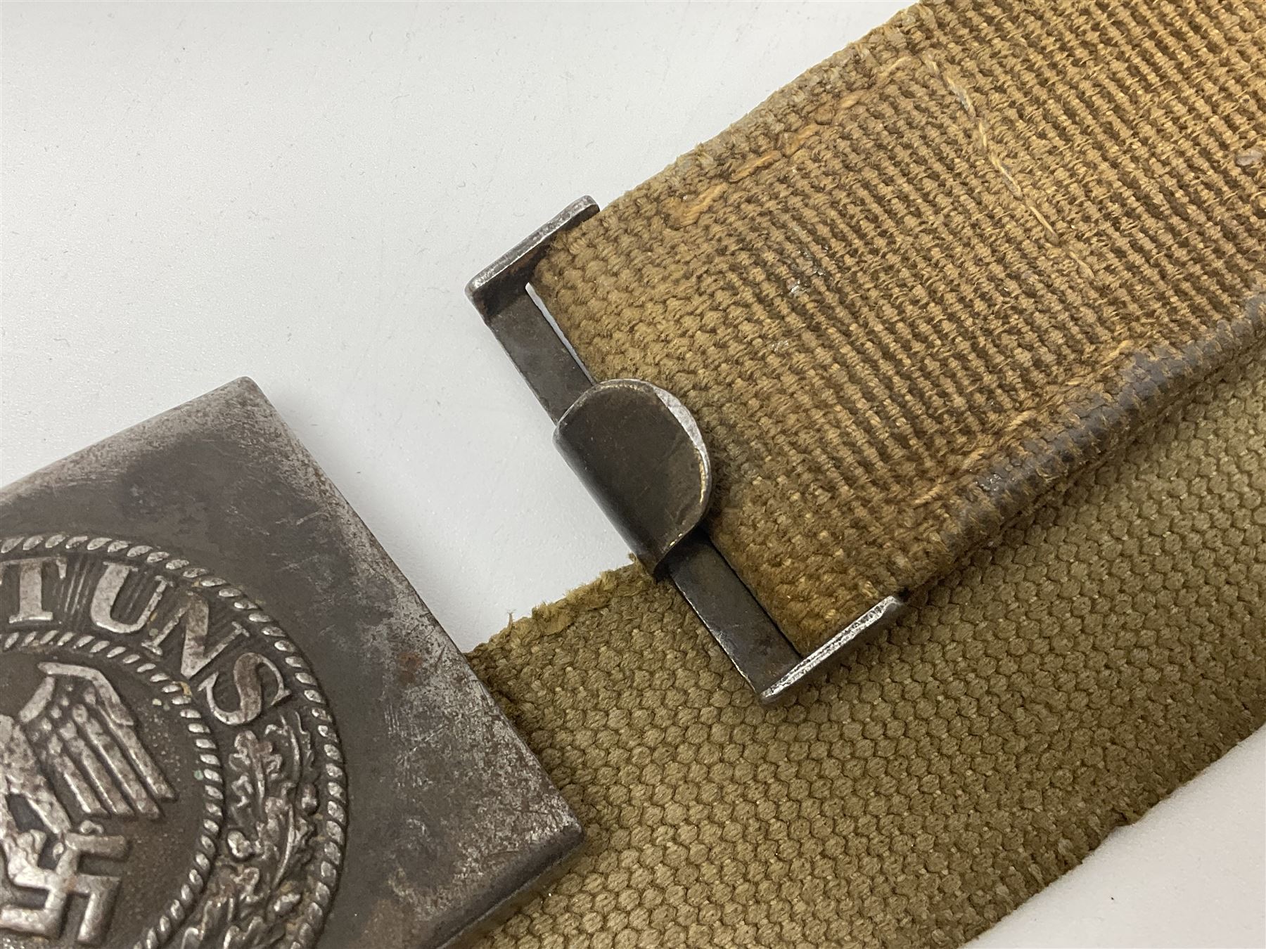 Pair of WW2 German Other Ranks trousers c1940-42, stamped C.& A. Brenninkmeyer Workstatten; WW2 German Army webbing belt with steel 'Gott Mit Uns' buckle; and WW2 German leather belt with 'Stahlhelm' (Steel Helmet League) members buckle (3)