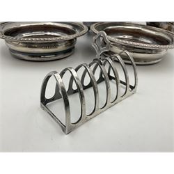 Silver plated seven bar toast rack by Mappin & Webb, together with other silver plated items including pair of bottle coasters, swing handled baskets and two sauce boats