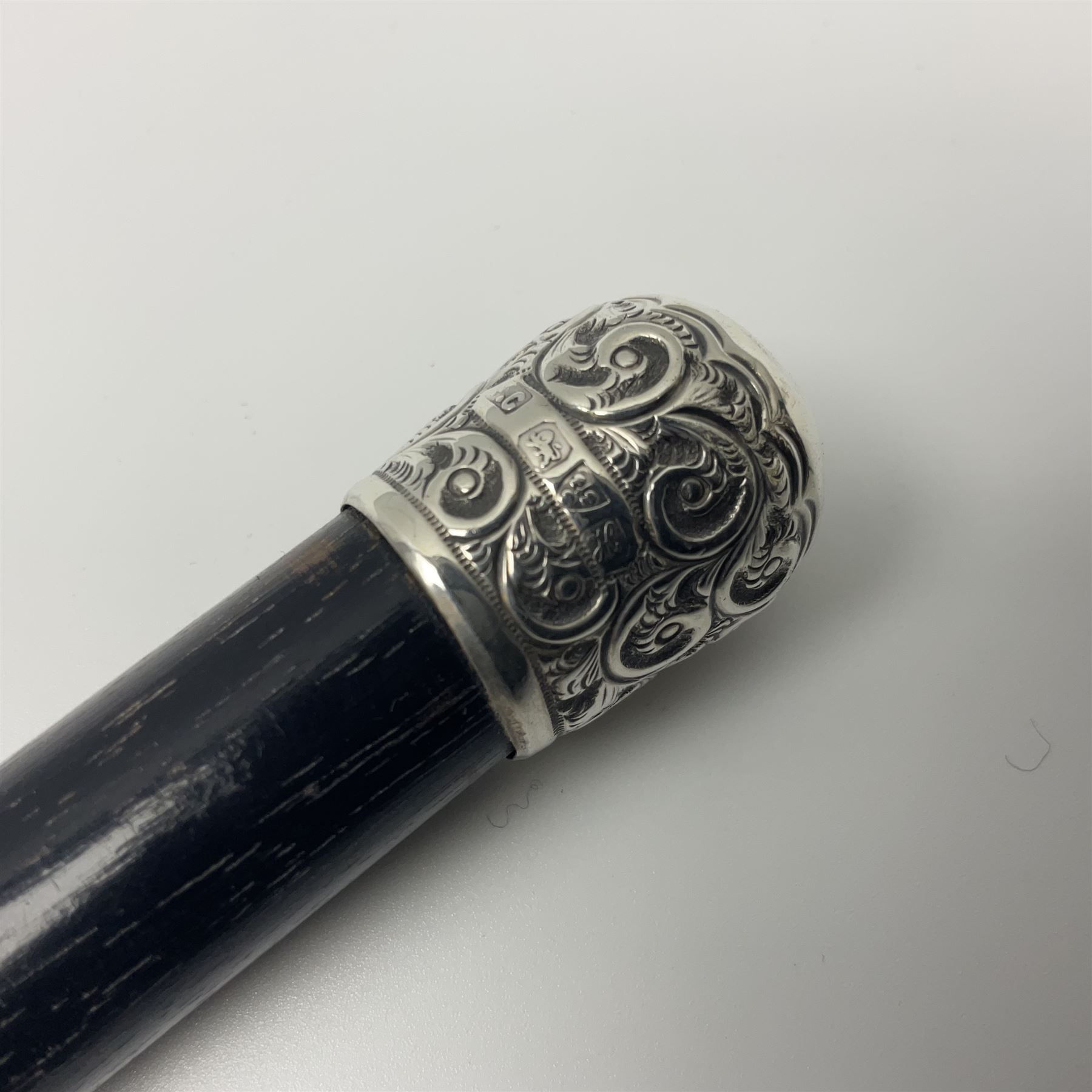 Two early 20th century conductor's ebonised batons each with three silver mounts; one hallmarked London 1915 with presentation plaque 'I.O.R. Presented to Mr. J.R. Maddock 4.1.17' L52cm; the other hallmarked Chester 1908 with vacant cartouche L51.5cm (2)