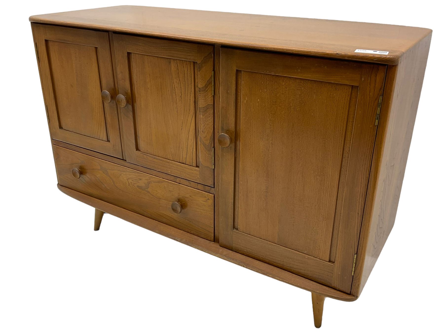 Ercol - elm and beech sideboard, fitted with cupboards and single drawer, enclosed by panelled doors, on splayed tapering feet