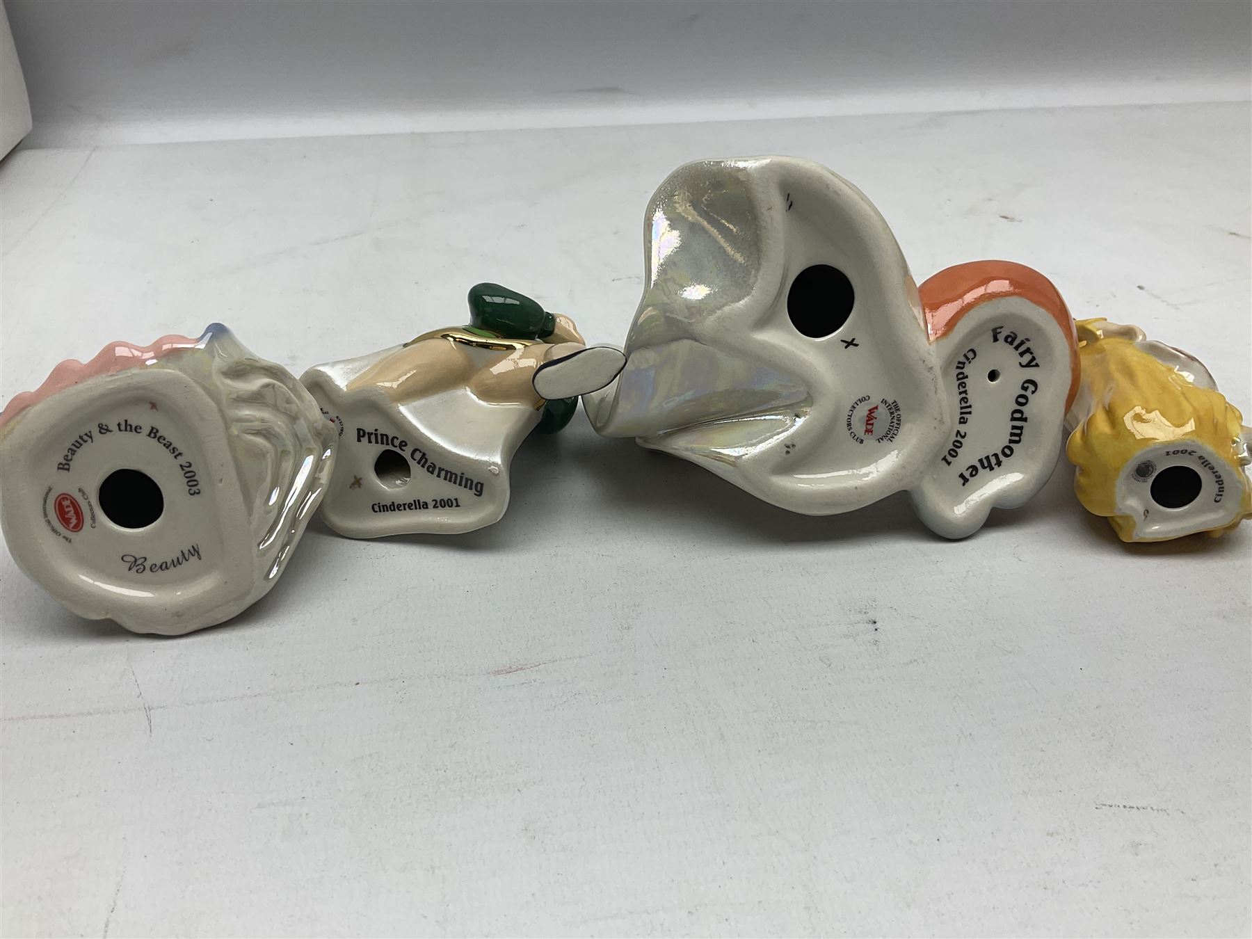 Thirteen Wade Collectors Club figures, comprising six Alice in Wonderland figures; Queen of Hearts, Alice, Mad Hatter, The Doormouse, White Rabbit and Cheshire cat, six Cinderella figures; Fairy Godmother, Cinderella Ready for the Ball, Prince Charming, Cinderella, Clorinda and Thisbe, together with Beauty from Beauty and the Beast, all with original boxes  