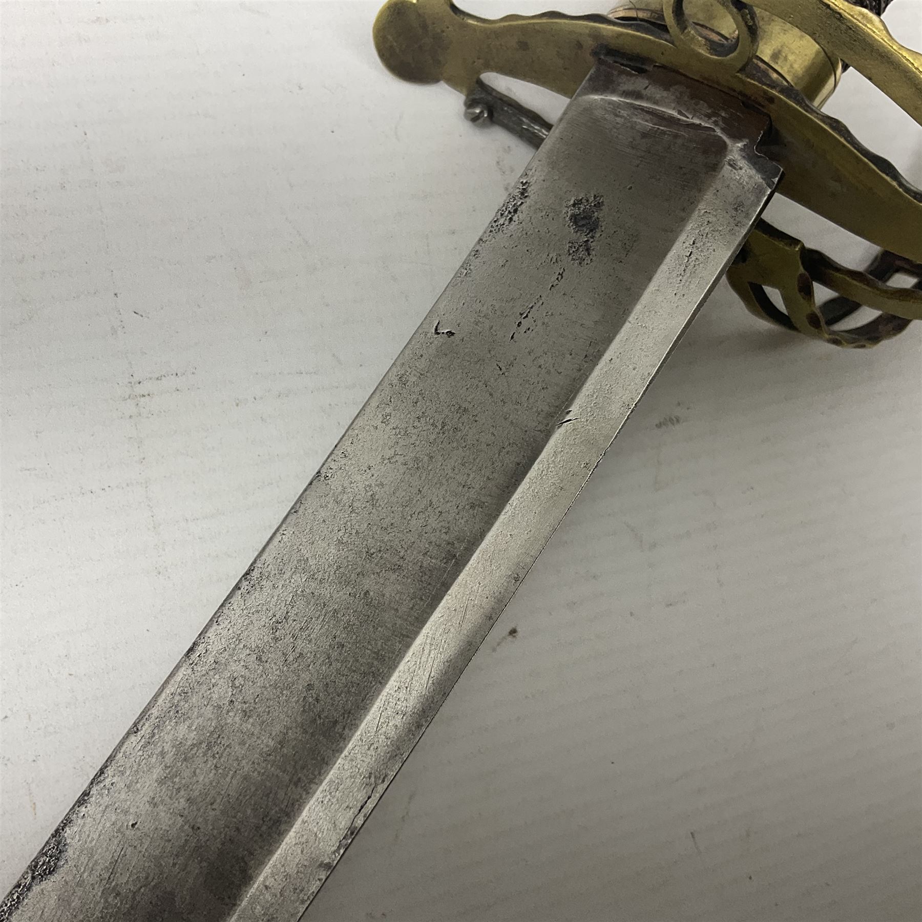 Late 18th century French 1st Empire Troupe a Pied Petit Montmorency Branch Tournante officer's sword, with 72.5cm slightly curving fullered blade, pierced brass hilt with lockable swivelling bar, fully wire-bound grip with lion head pommel, L88cm overall (no scabbard)