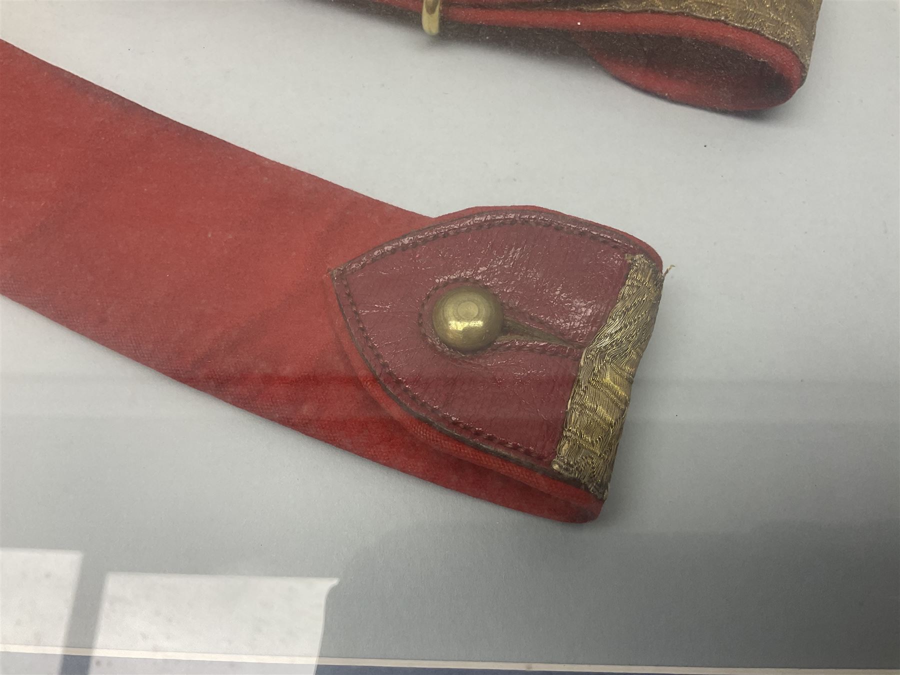 Victorian / Edward VII Queens Own Hussars Officers Full Dress Pouch and Cross Belt; scarlet cloth covered leather pouch with bullion embroidered crown, laurel bordered regimental crest within an edge of embroidered bullion wire; with its original officers cross belt with fine regimental pattern brocade to the top and gilt metal furniture; displayed in a wall hanging case with cloth and metal regimental badges; mahogany stained frame 44 x 54cm