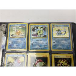 Collection of Pokemon trading cards, mostly 1999 Wizards Pokemon cards to include holo Charizard 4/102, first edition holo Machamp 8/102, further holographic cards; Dark Flareon 35/82 and Dark Vaporeon 45/82, cards from themed sets and 4th edition prints; 1998 Electronic Pokédex with cardboard boxes for themed decks Blackout, Overgrowth and Power Reserve Jungle, along with a large quantity of energy and trainer cards 