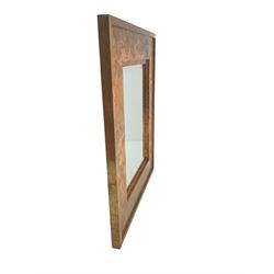 Copper framed mirror, rectangular bevelled plate, the wide stepped frame with an iridescent finish