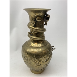 A large Chinese brass vase, of ovoid form with tall neck and flared rim, decorated in relief with dragons chasing a flaming pearl, and further incised with clouds and other detail, the base with relief dragon detail and character mark, H41