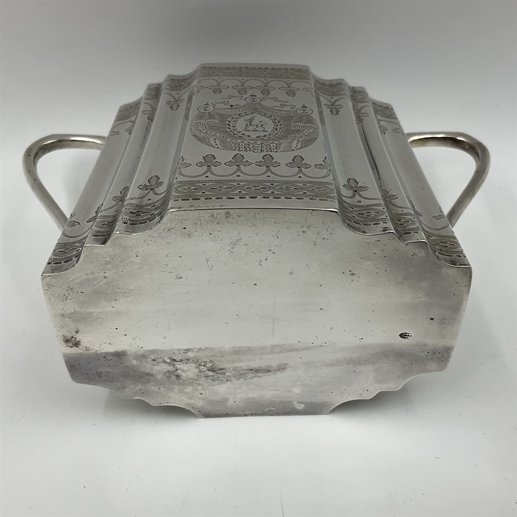 Victorian three-piece silver tea service, comprising teapot, twin handled open sucrier and milk jug, of oval form with shaped rim and C handles, each engraved with crests and bands of strapwork decoration, the milk jug and sucrier with gilt interiors, hallmarked Josiah Williams & Co, Exeter 1881, the teapot with ivory insulators and finial, all contained with a tooled leather, blue silk and velvet lined fitted case, retailed by West & Sun, Dublin 
This item has been registered for sale under Section 10 of the APHA Ivory Act